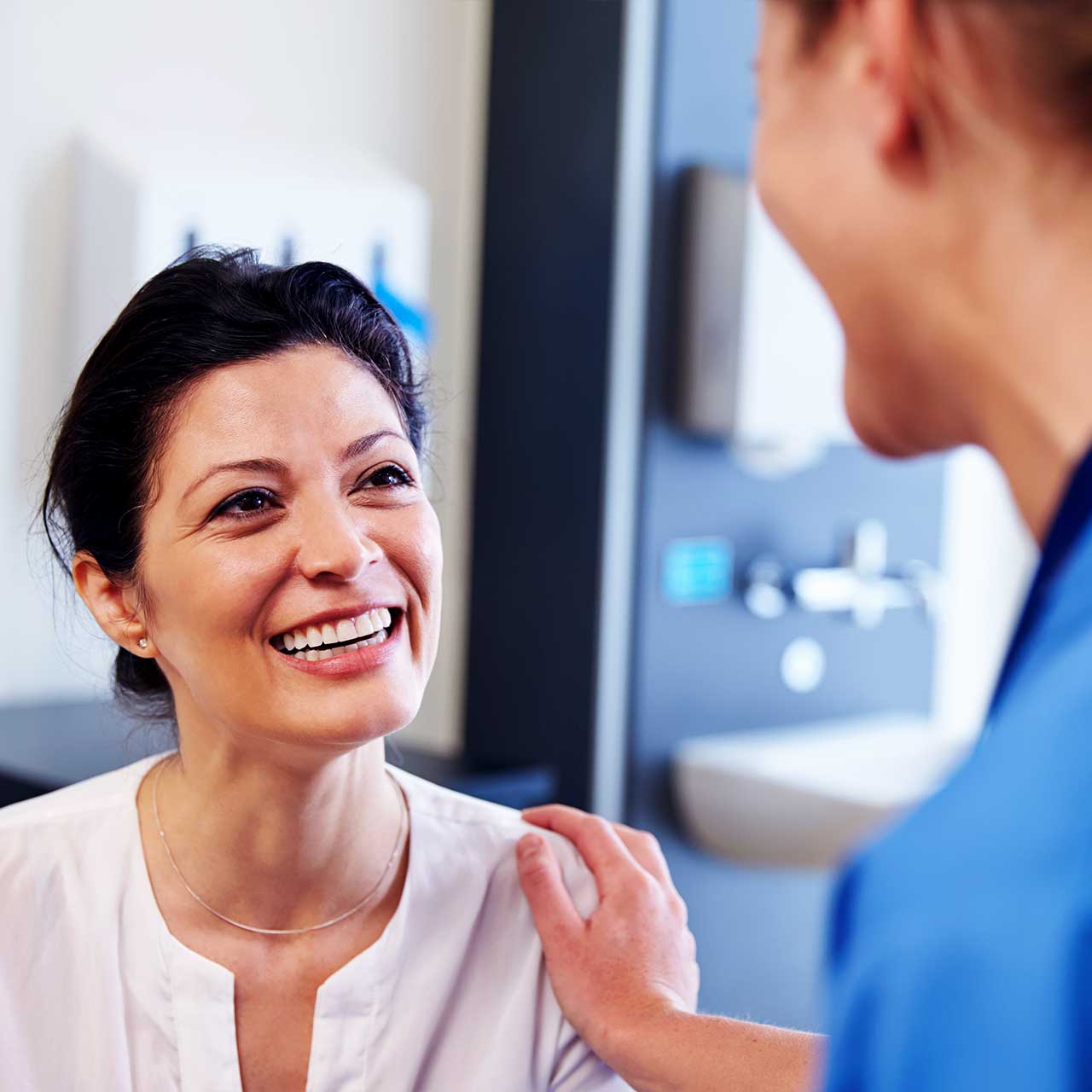 Smiling patient speaking with her doctor